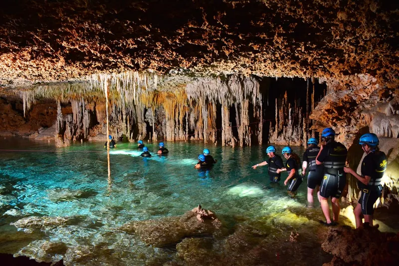 Crystal-clear underground river with stalactites at Río Secreto on a cave tour near Playa del Carmen, Mexico