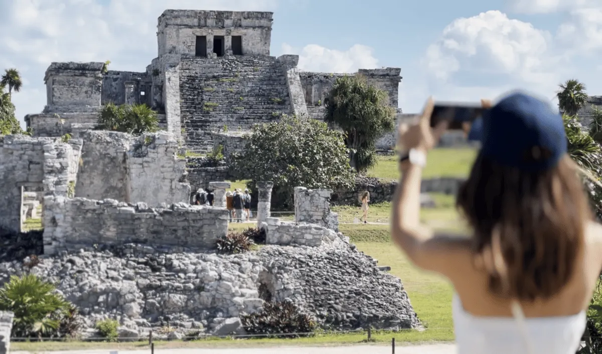 Tulum Maya ruins on a cliff above the turquoise Caribbean Sea on a day-trip tour from Playa del Carmen, Mexico
